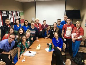 team of nurses wearing christmas sweaters