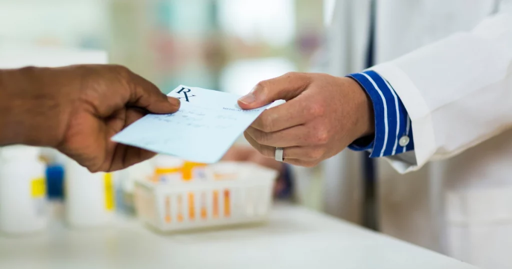 patient handing pharmacist prescription for translating prescriptions