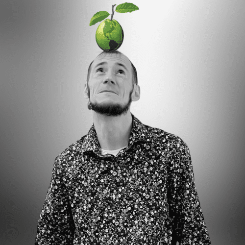 black and white headshot photo of David Deitz looking up at green Linguava globe on his head