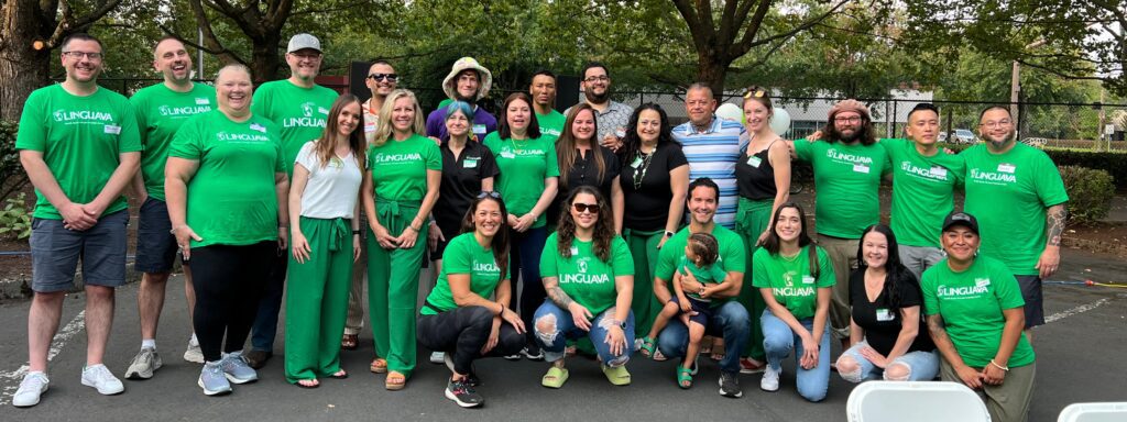 a group shot of the team at Linguava outside, most wearing green Linguava tshirts