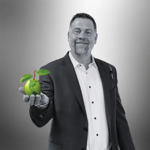 black and white photo of Matt Duscsik, Linguava COO, holding a green guava globe in his outstretched hand